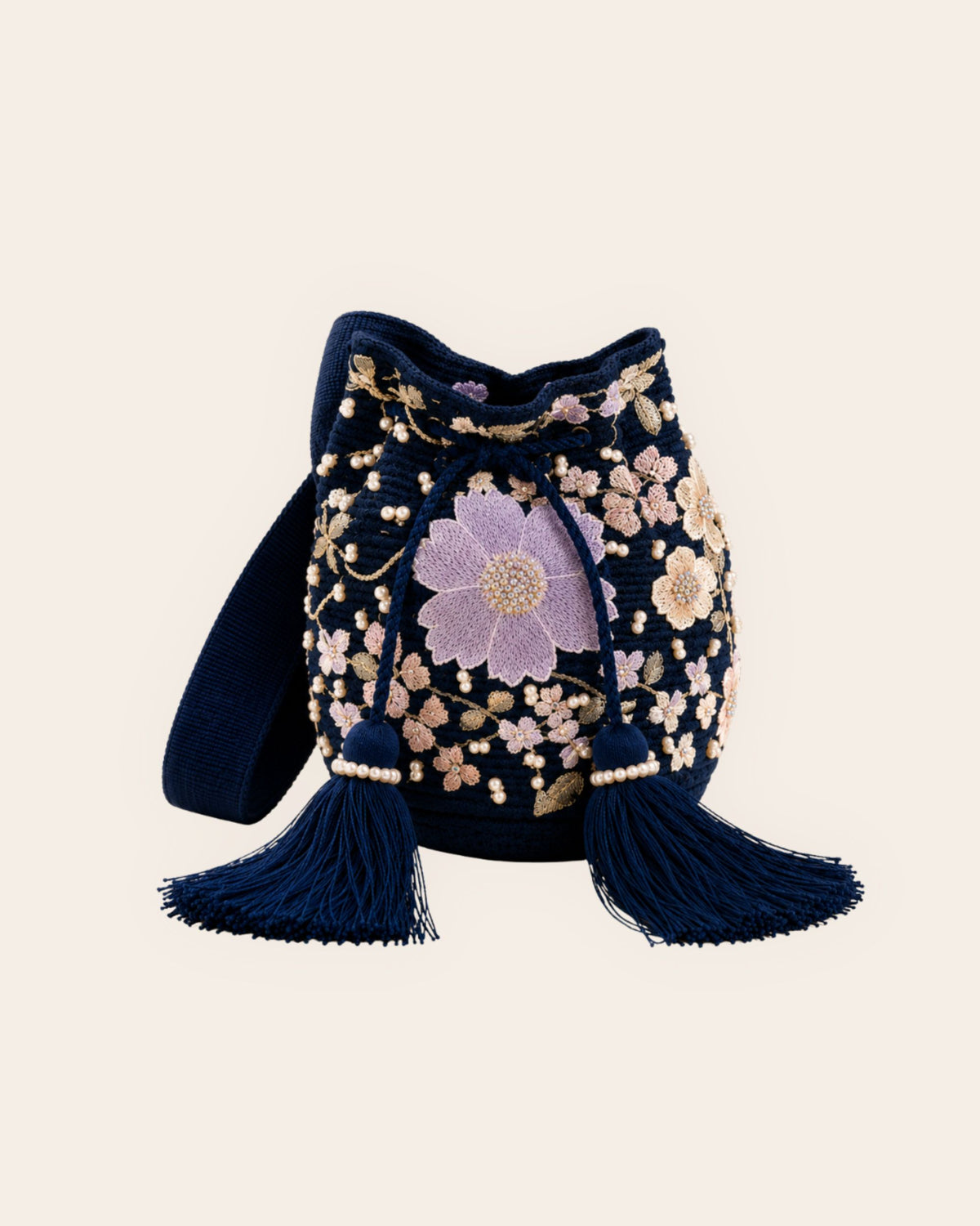 Maresa Midnight Bloom navy handmade occasion bag with lilac floral appliqué, pearl embellishments and statement tassels.