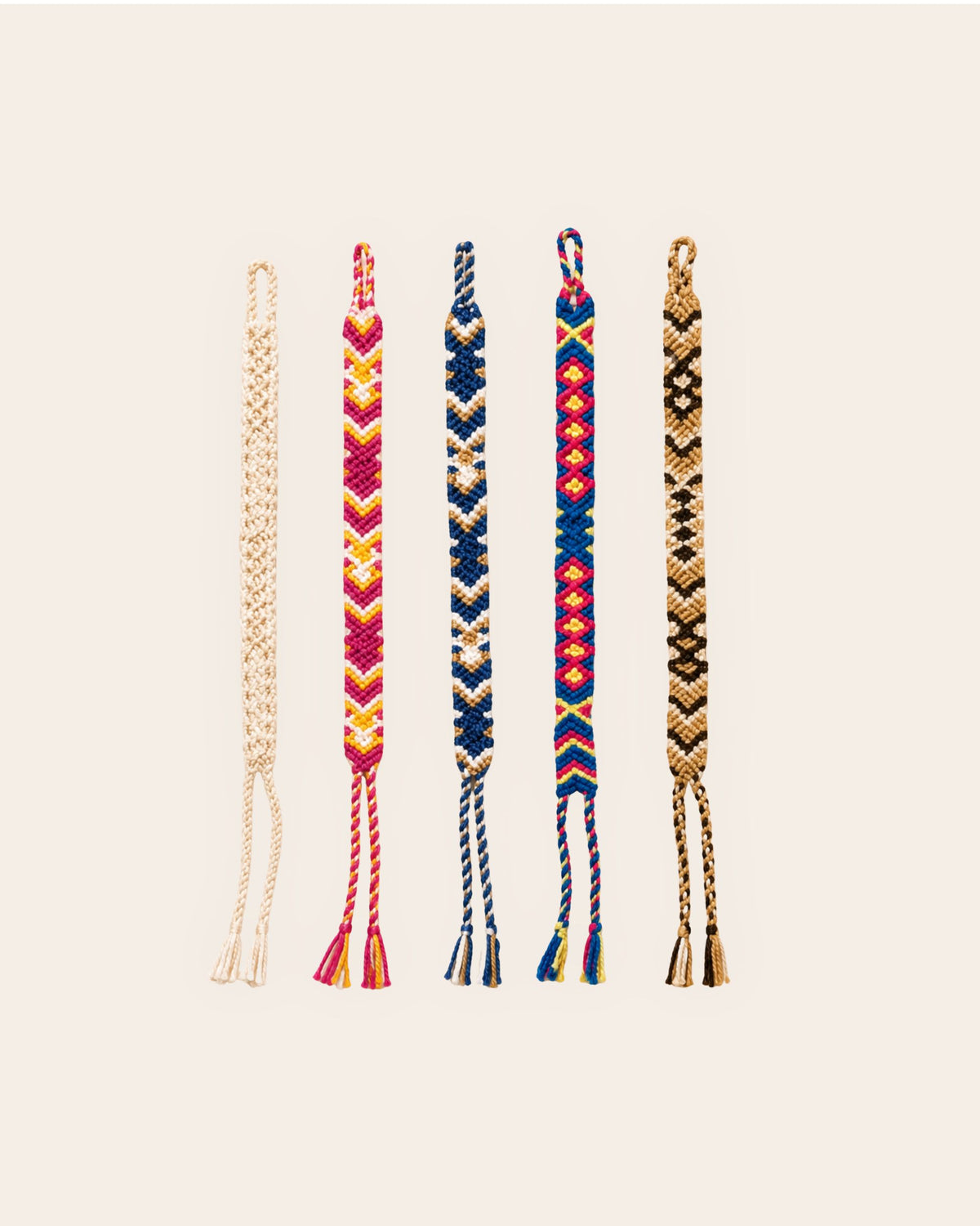 Five Maresa handmade Wayuu woven bracelets in ivory, fuchsia, navy, multicolour and chocolate designs