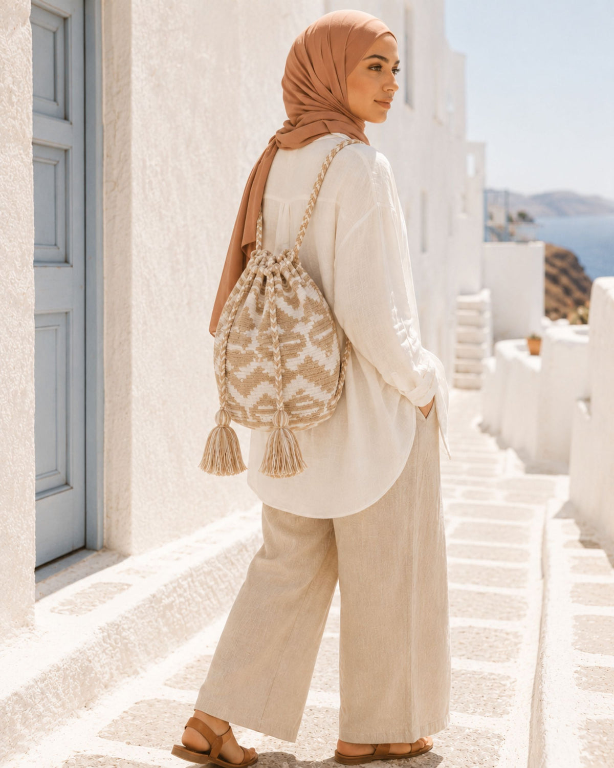 Model wearing the Maresa Sand & Ivory Handwoven Drawstring Backpack
