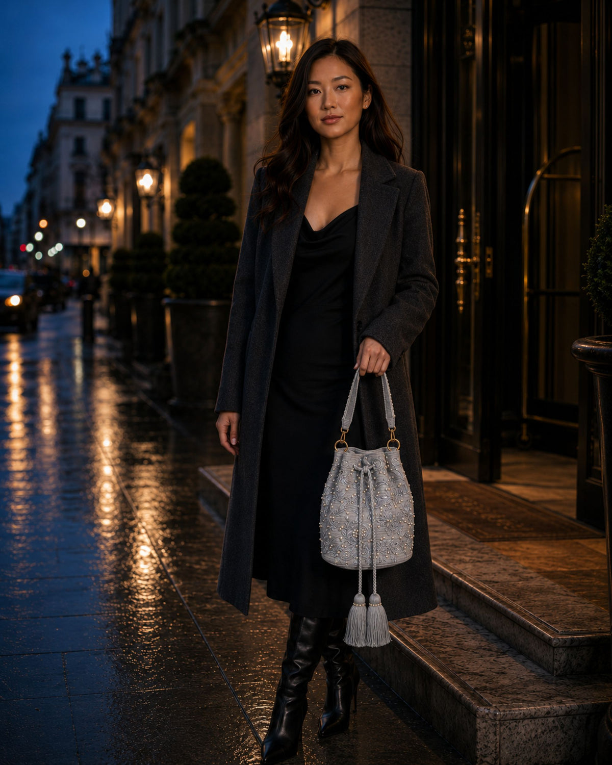 Pearl grey botanical embellished occasion bag carried with a dark coat for an evening occasion