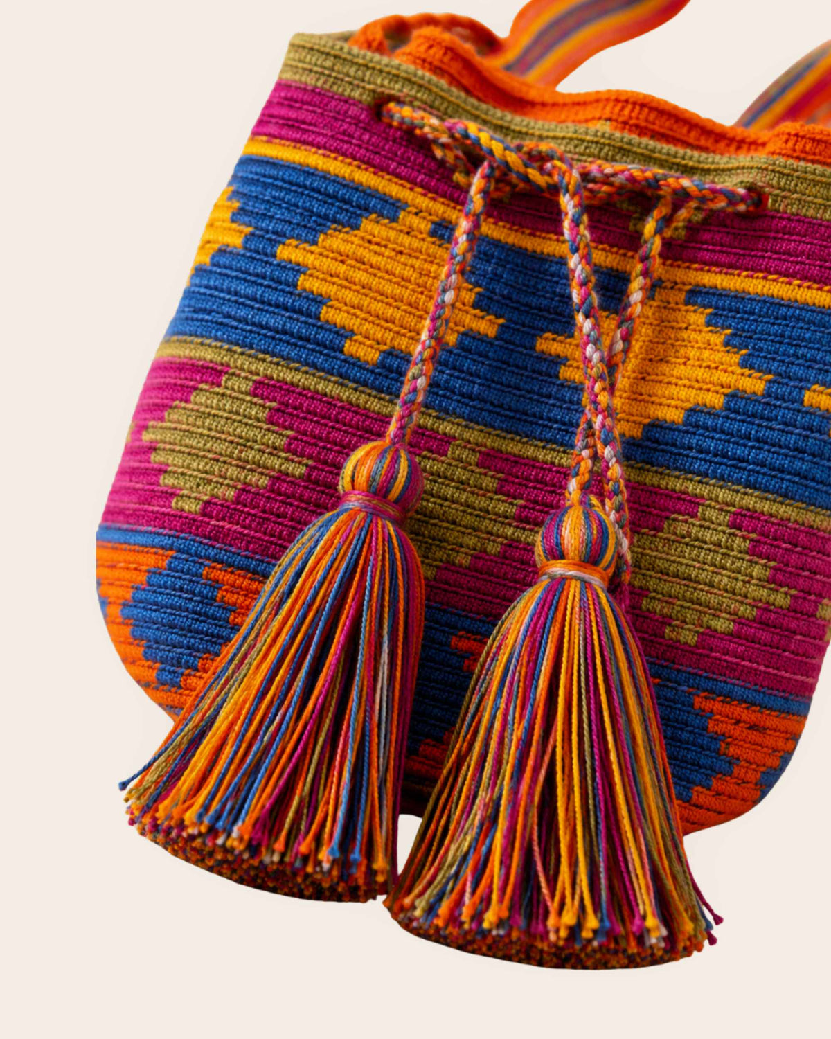 Detailed view of the handmade braided drawstring and tassels.