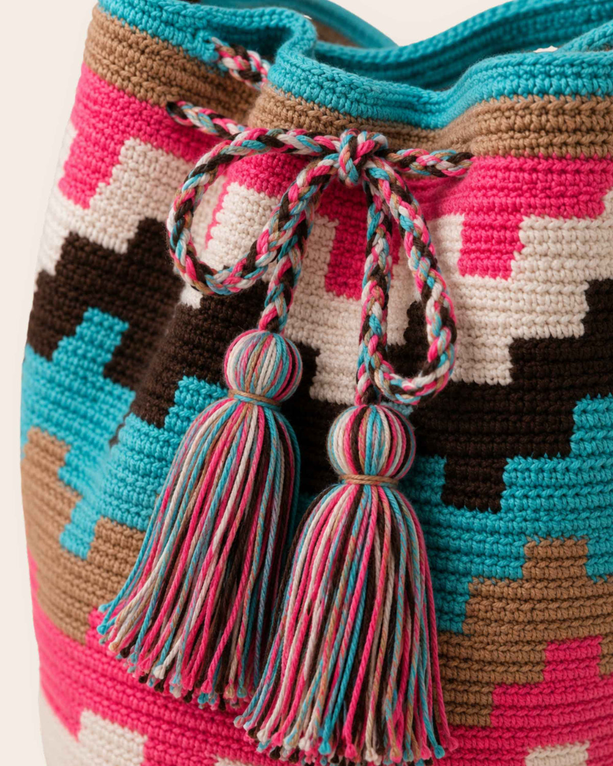 Detailed view of the handmade braided drawstring and tassels.