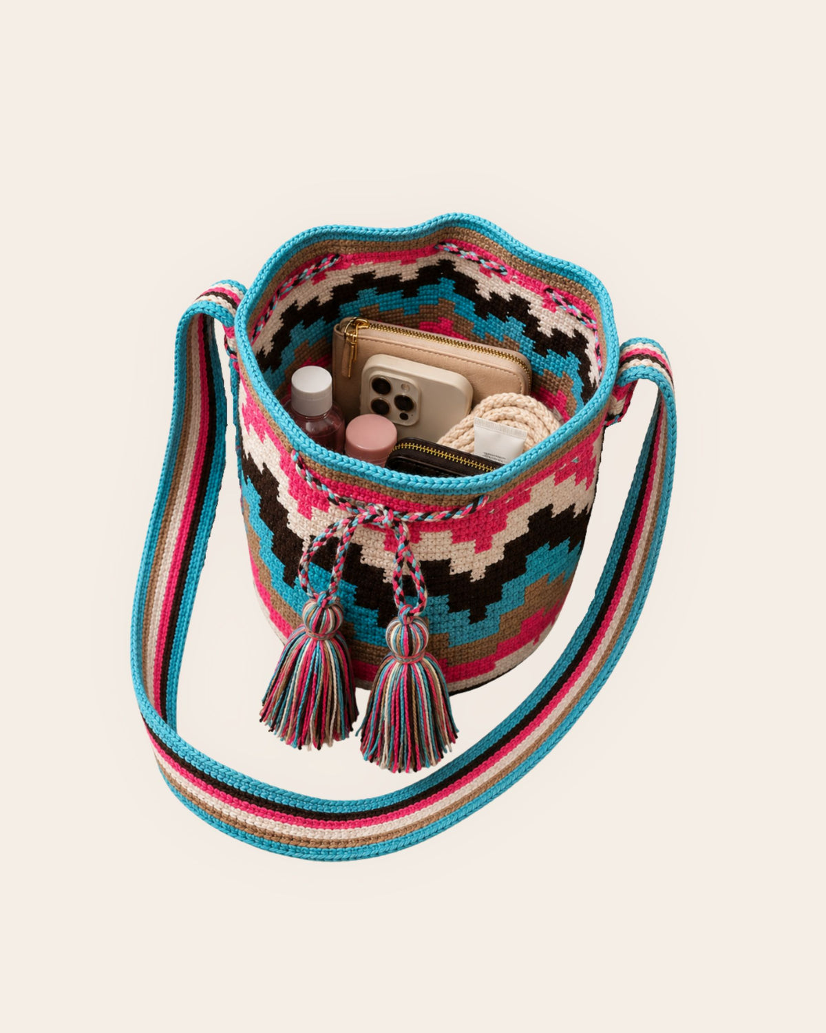 Interior capacity of the Maresa Turquoise, Fuchsia & Chocolate Wayuu Crochet Mochila.