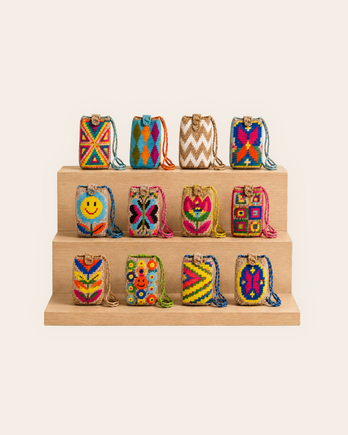 Collection of colourful handmade mini crossbody bags displayed on wooden shelves 