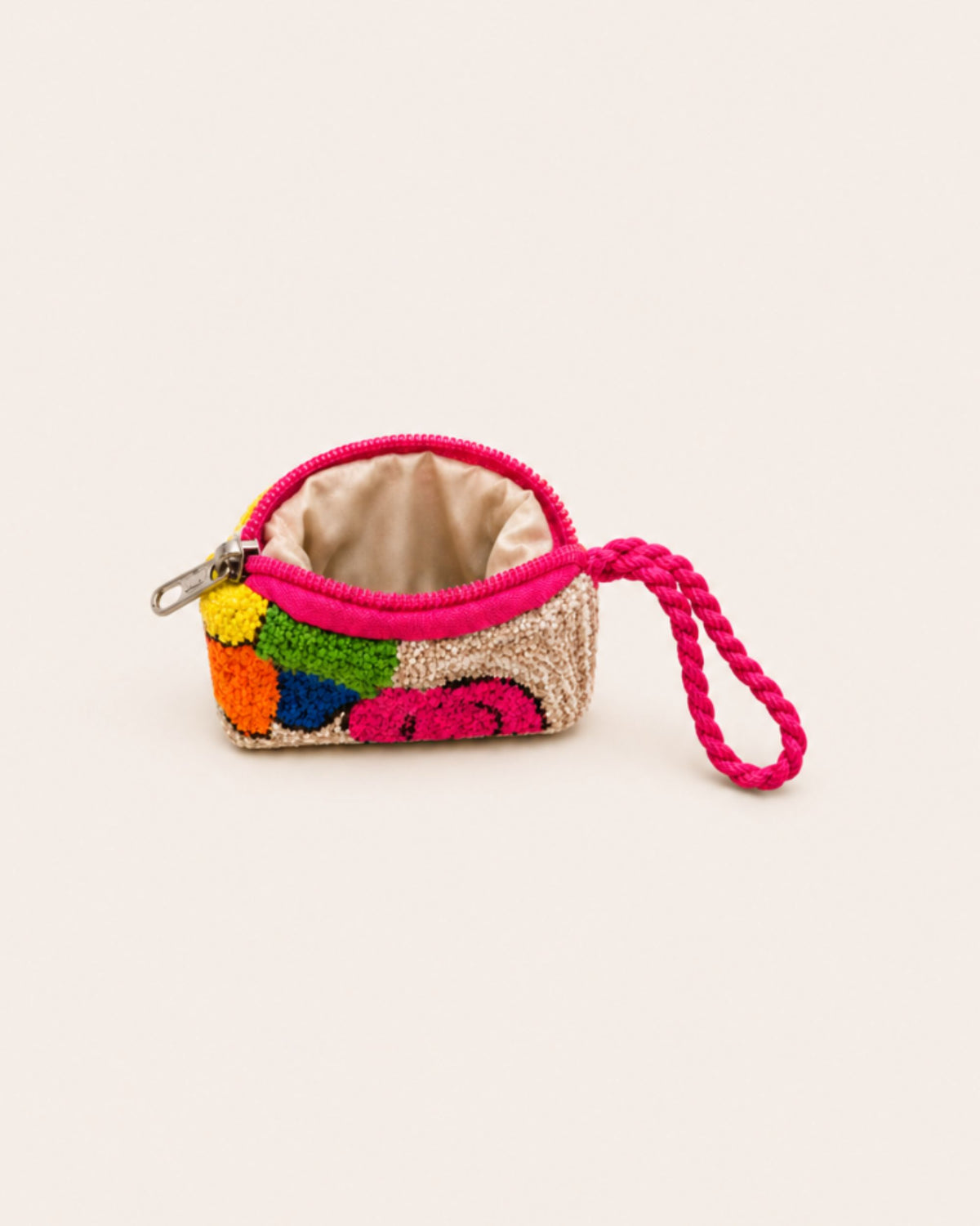 Handmade multicolour textile mini pouch with pink zip closure, braided wrist strap and waterproof fabric lining