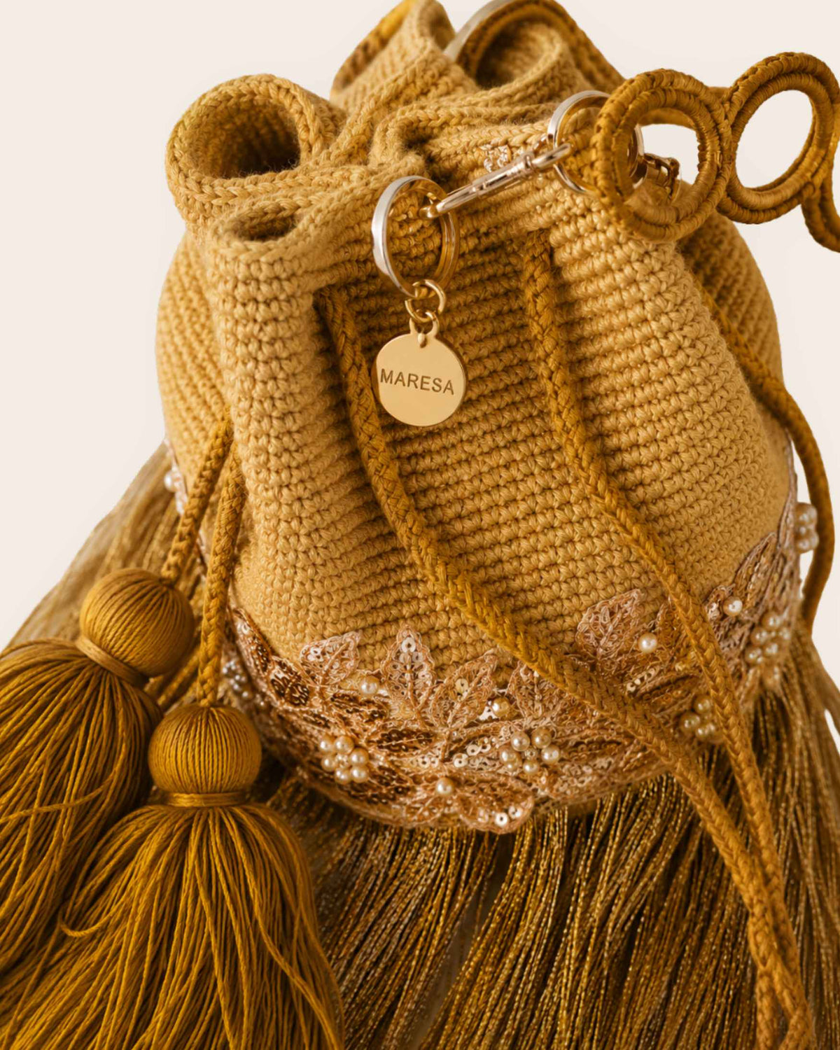 Maresa Golden Ochre Fringe Embellished Handmade Occasion Bag signature charm detail 