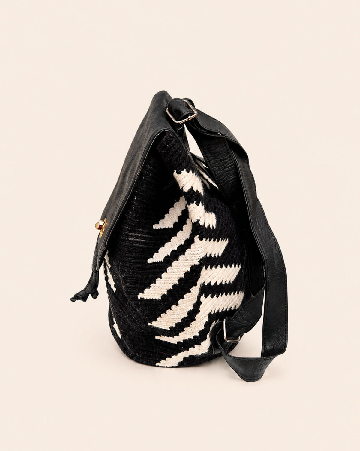 Gold-tone twist-lock fastening detail on Maresa flap backpack 