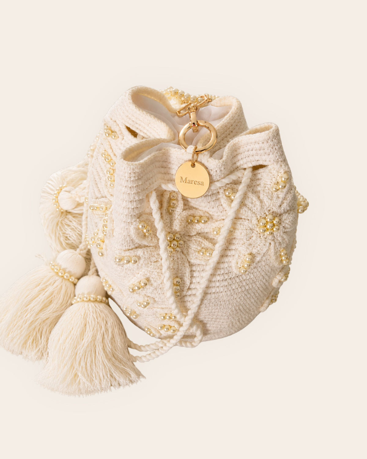 5.	Maresa Ivory Pearl Blossom Embellished Handmade Occasion Bag signature charm and craftsmanship detail 