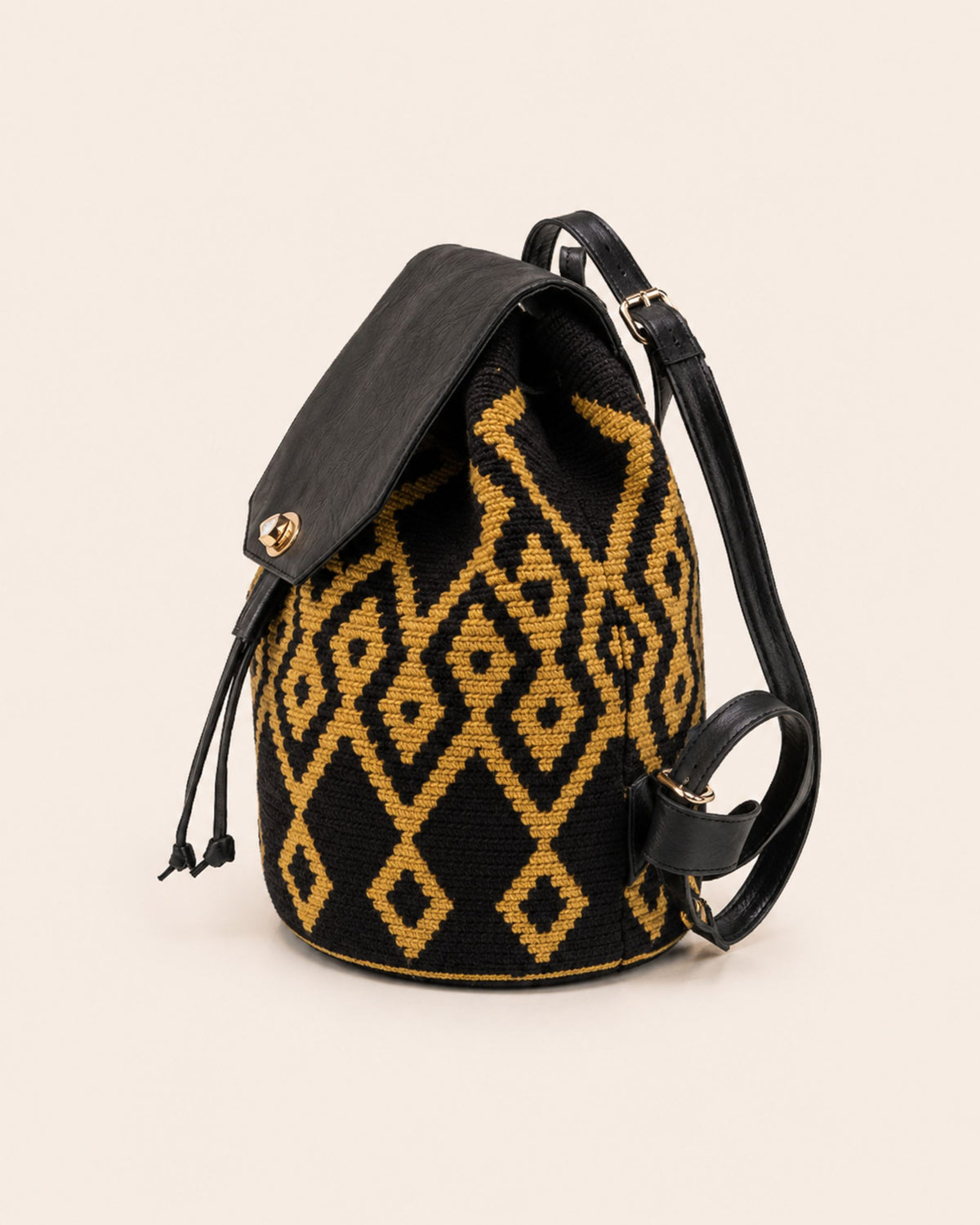 Gold-tone twist-lock fastening detail on Maresa flap backpack 