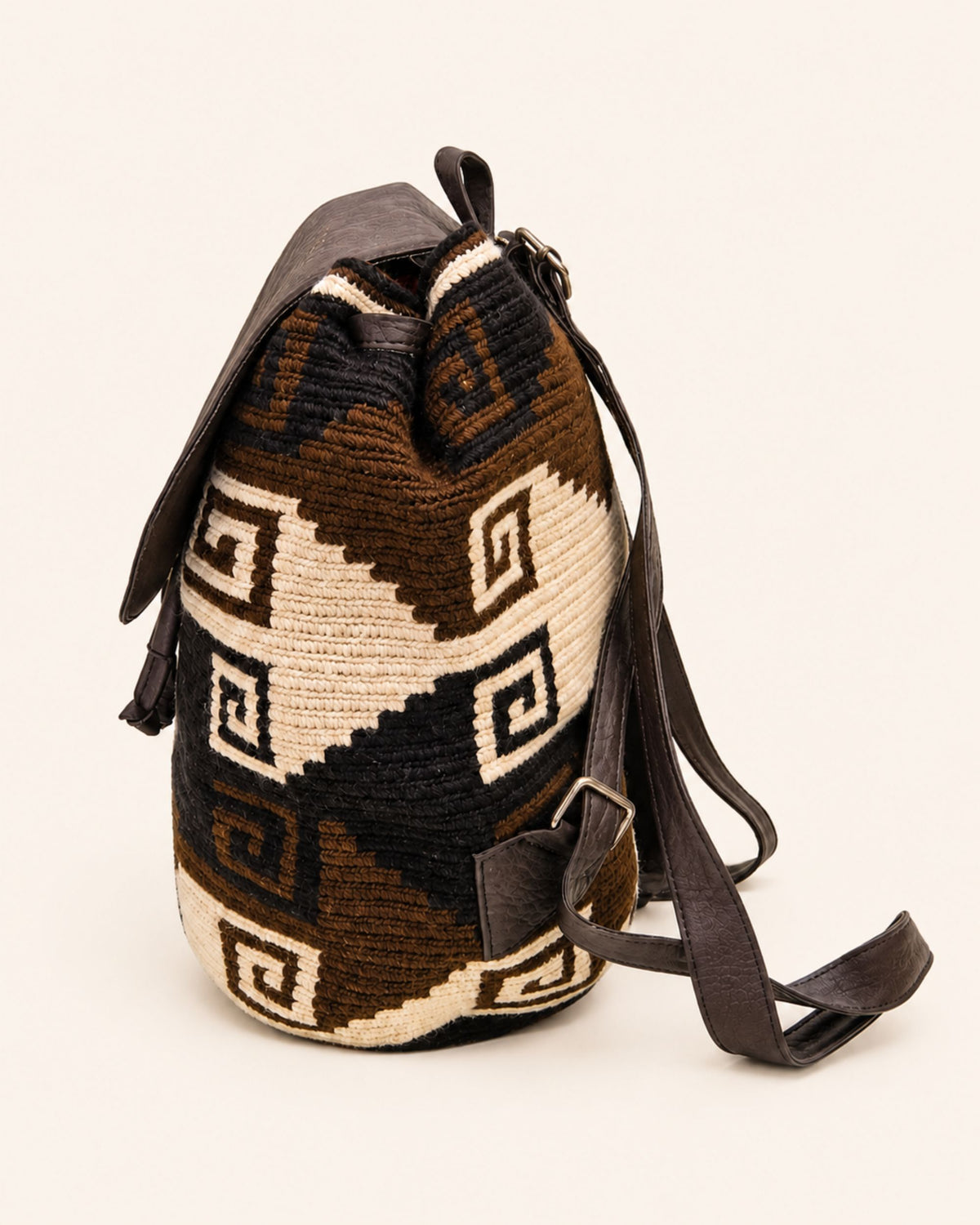 Gold-tone twist-lock fastening detail on Maresa flap backpack 