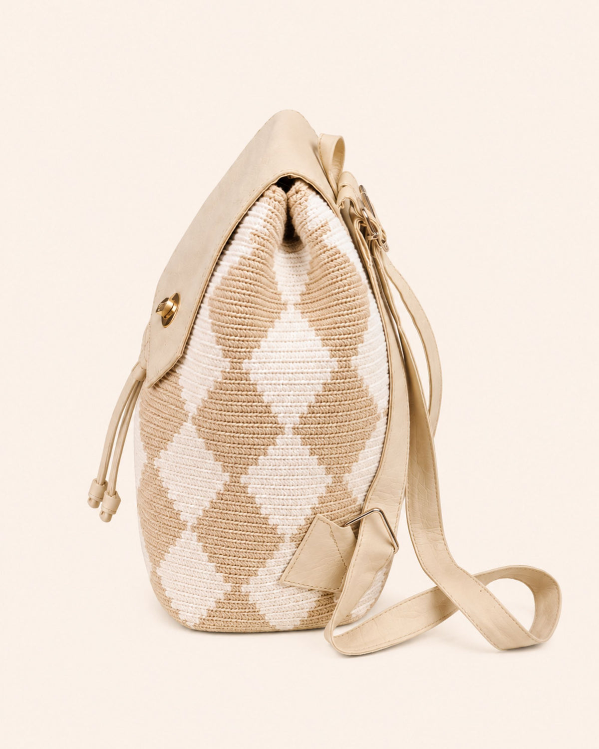 Gold-tone twist-lock fastening detail on Maresa flap backpack 