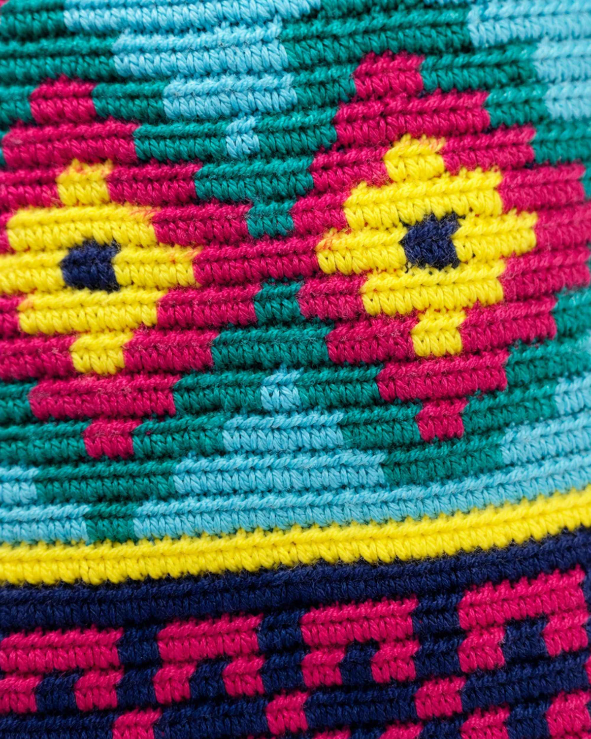 7.	Side profile of Maresa Fuchsia & Turquoise Wayuu Crochet Flap Backpack 