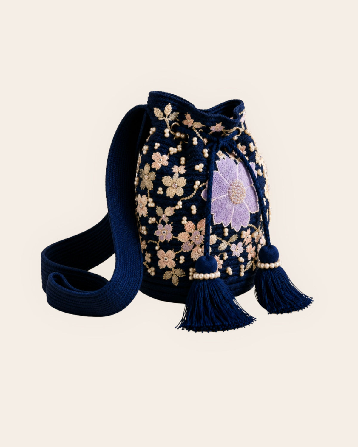Side view of the Midnight Bloom navy handmade bag with floral embellishments, shoulder strap and tassels. 