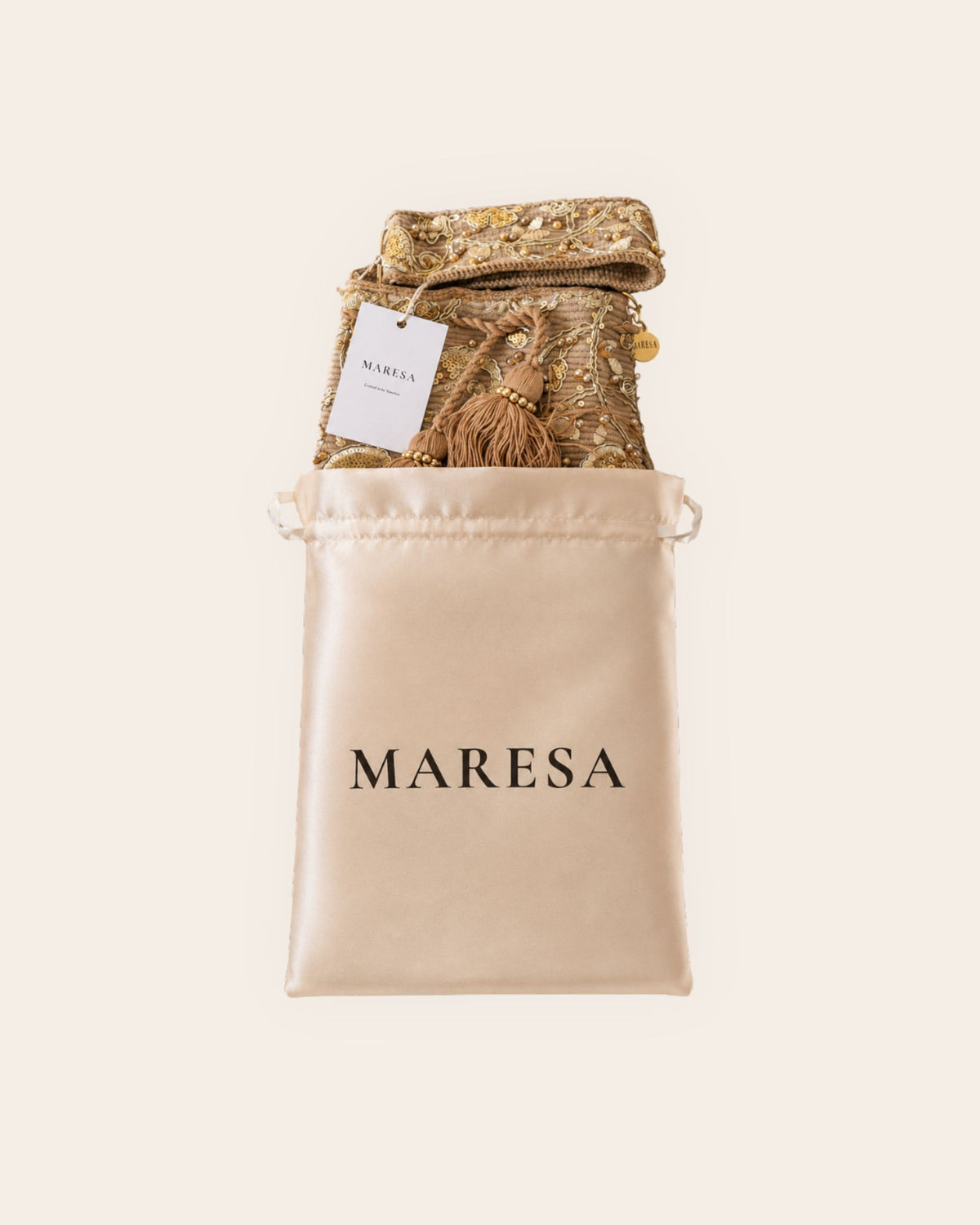 Champagne gold embellished Maresa occasion bag presented with satin branded storage bag