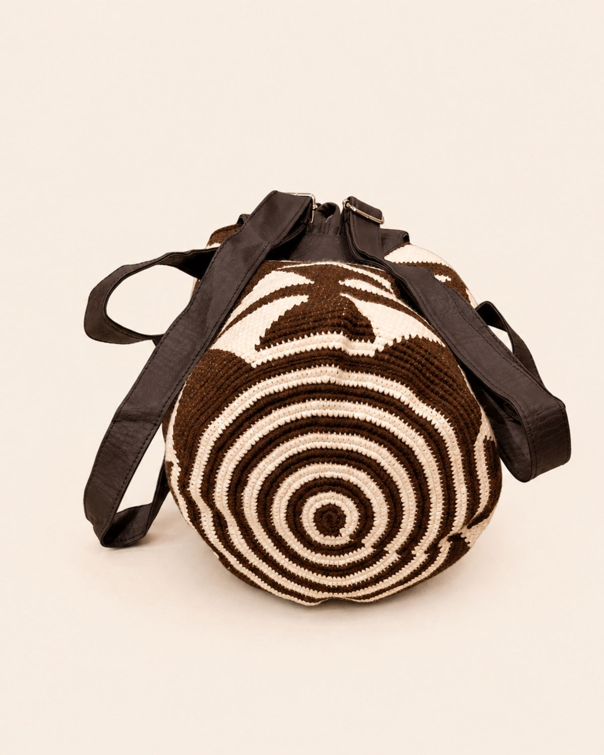 Circular crochet base and adjustable straps of the Chocolate & Ivory Wayuu Crochet Flap Backpack