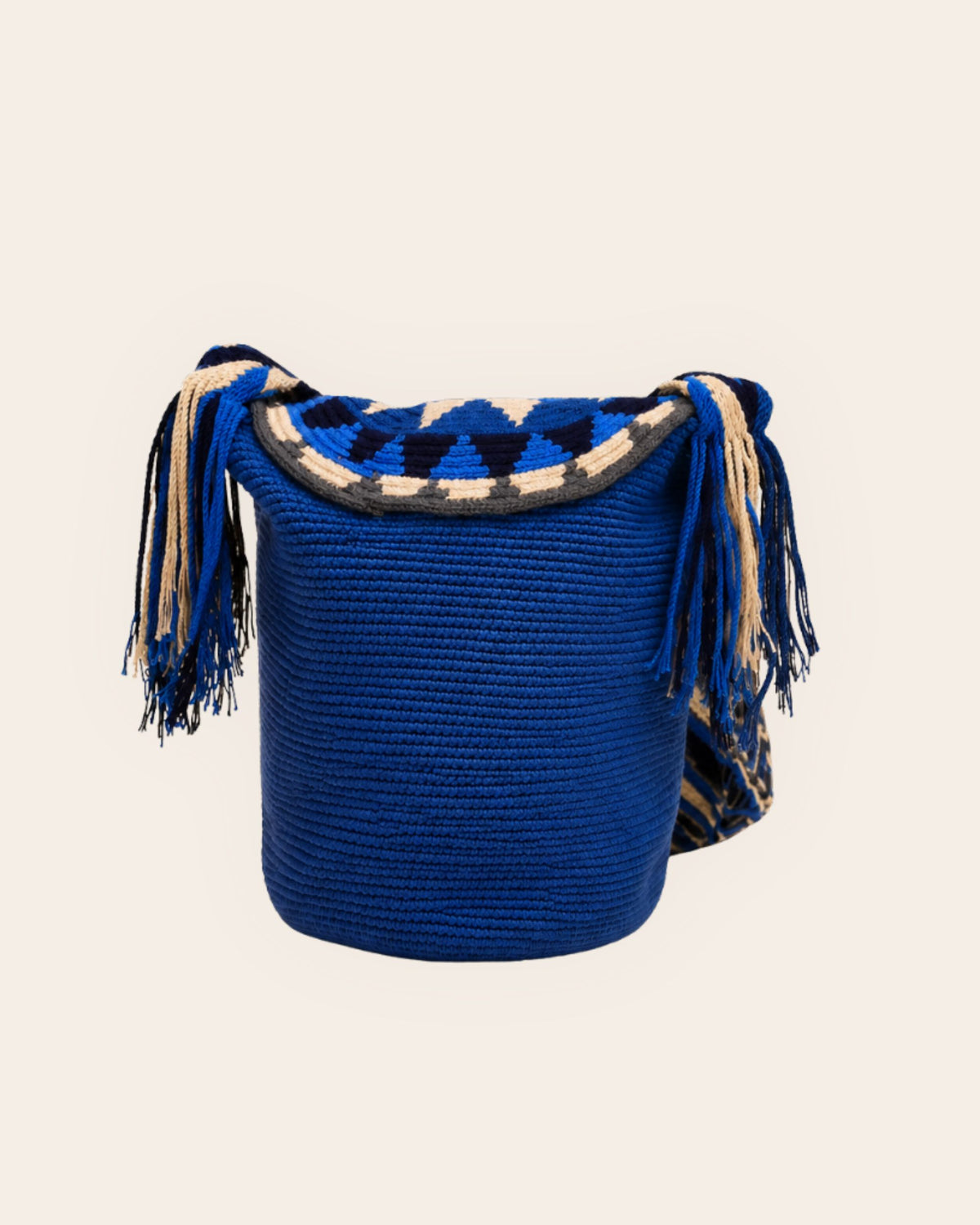 Back view of cobalt blue Wayuu crochet flap bucket bag showing handcrafted crochet body and flap details.