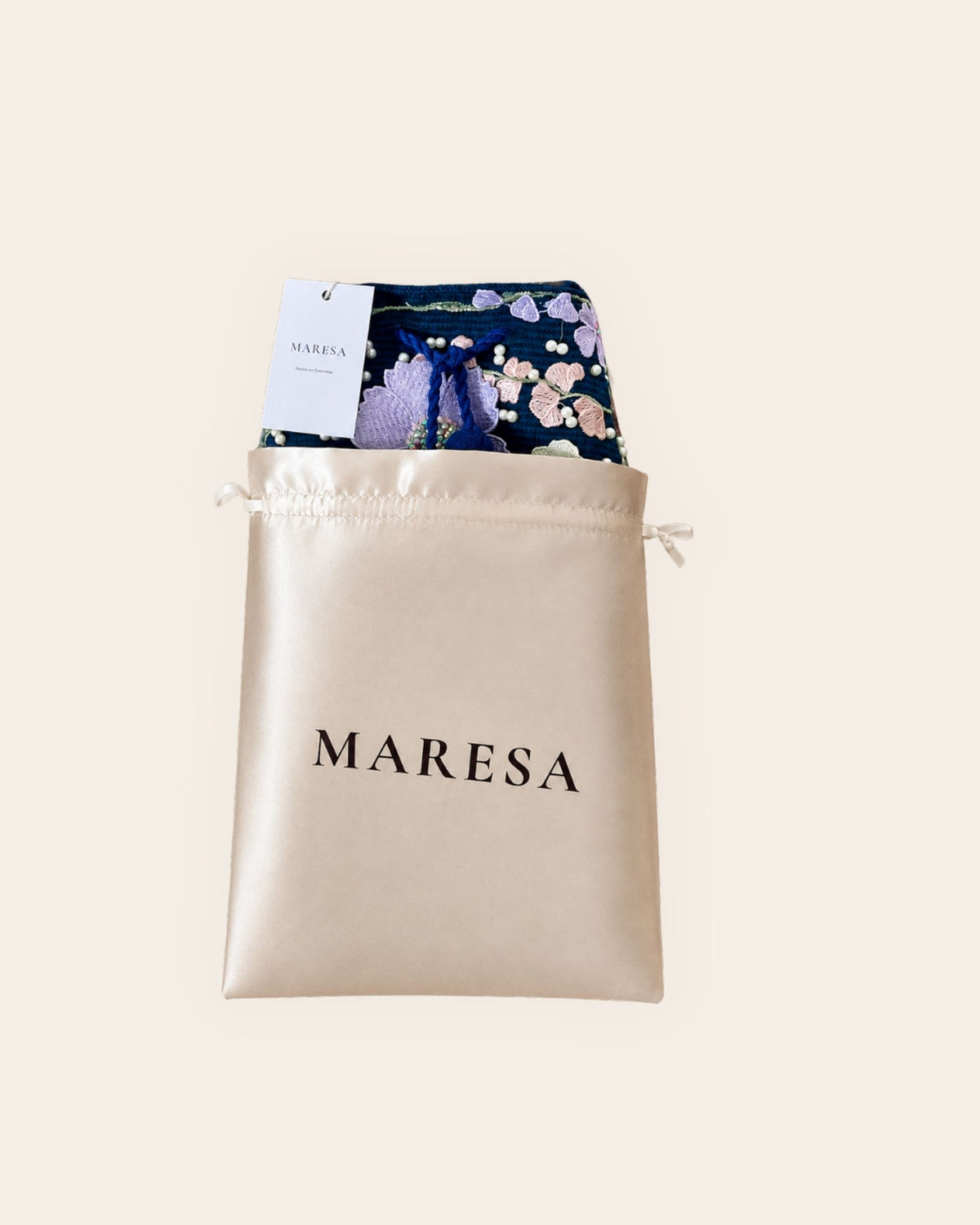 Maresa Midnight Bloom embellished occasion bag presented with its champagne satin Maresa dust bag.