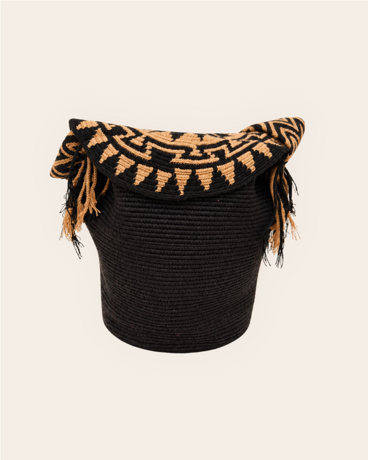 Back view of the black Wayuu crochet Flap Bucket Bag showing the handcrafted crochet body and patterned flap.